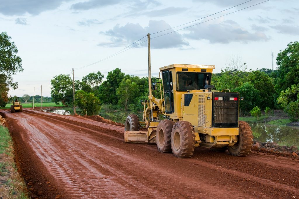 Road graders on red soil
