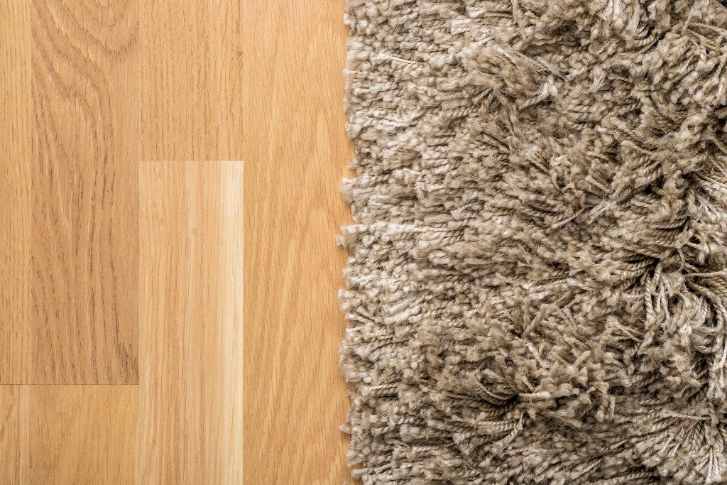 Fluffy carpet on wooden floor