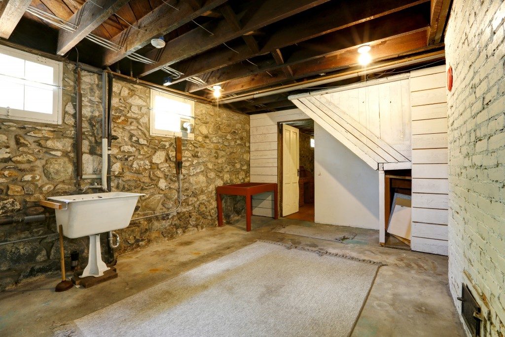 basement with stone wall and old sink