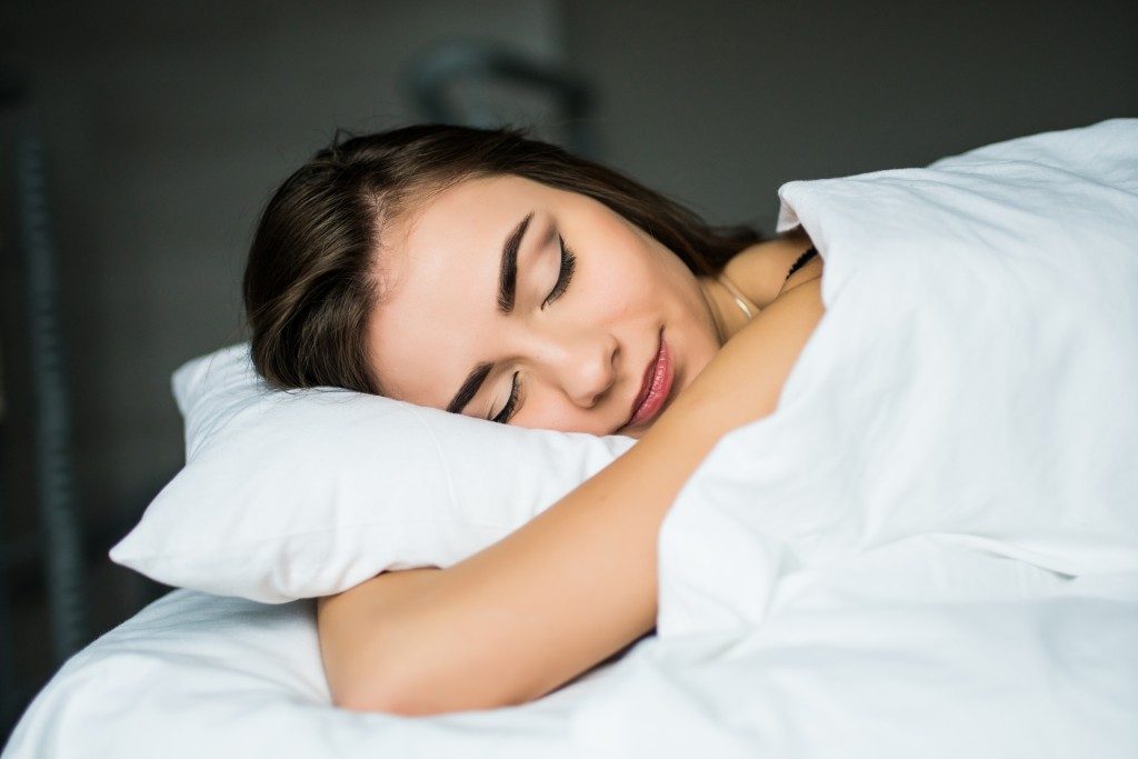 Female sleeping while hugging her pillow