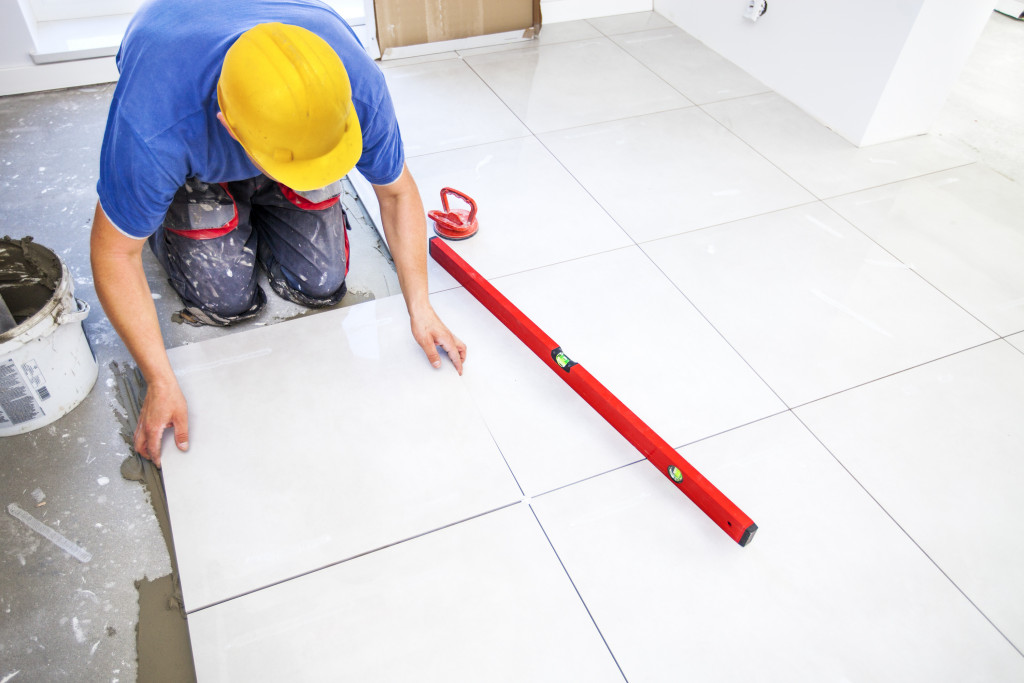 a person installing floor tiling