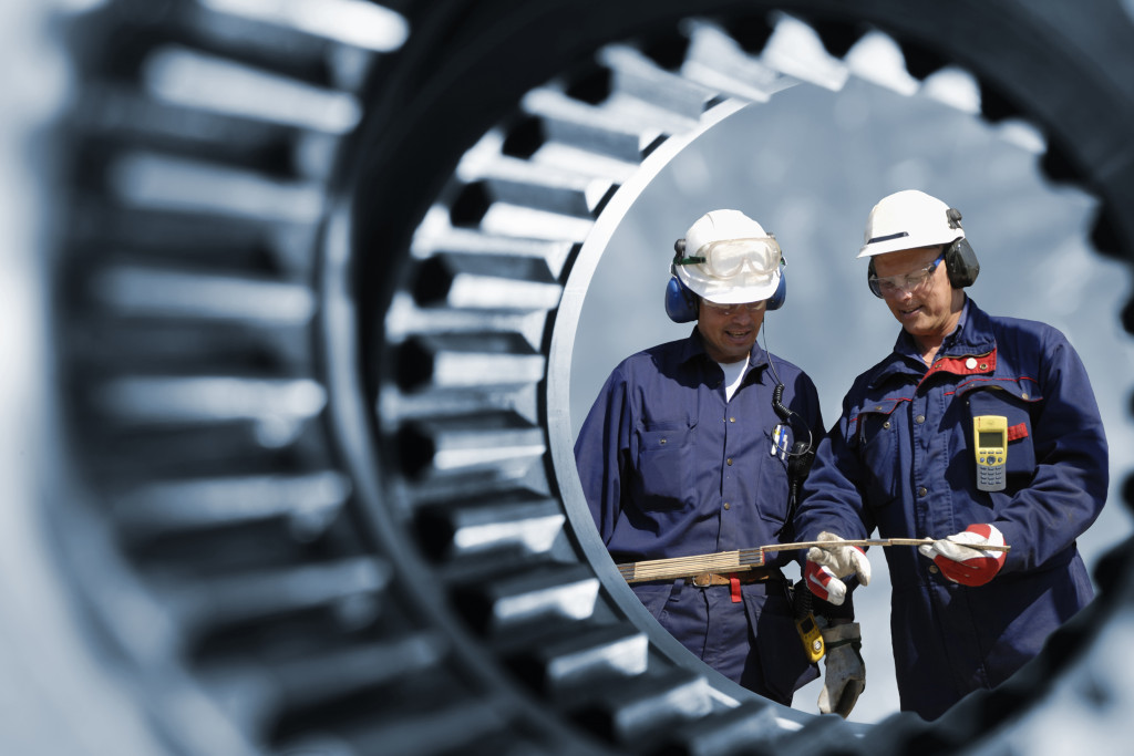 Two workers checking equipment